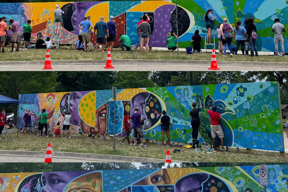 People paint a mural.